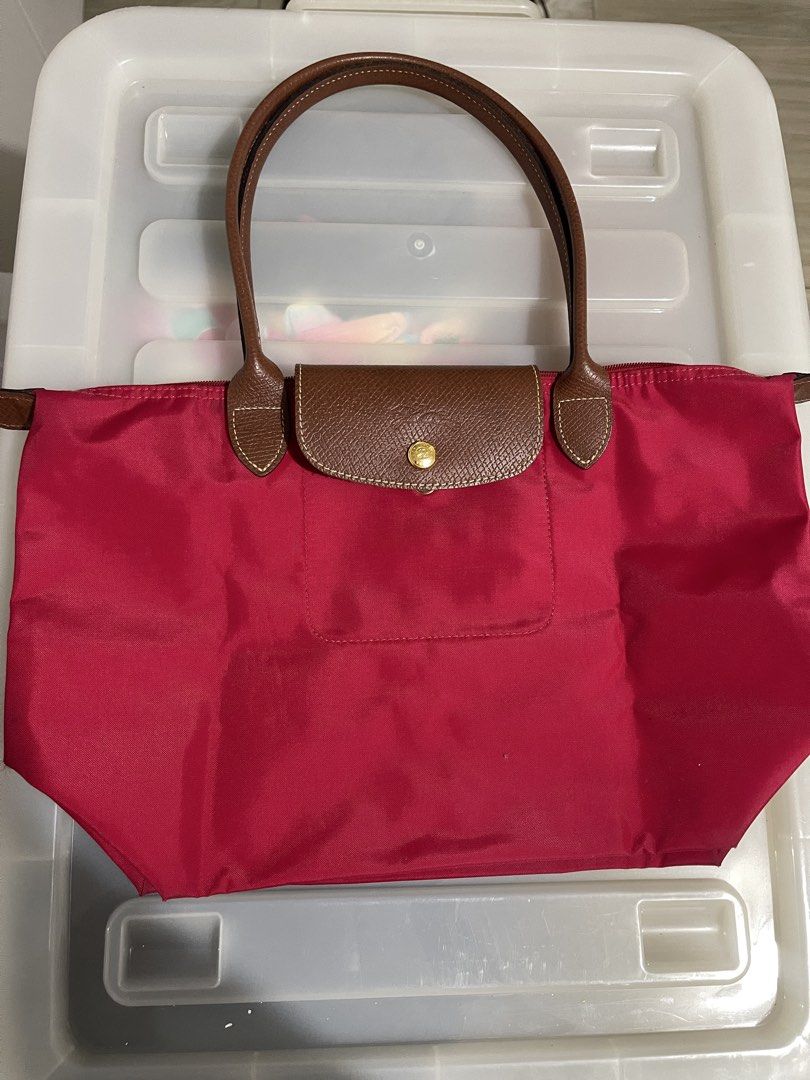 Longchamp Paris Red Nylon Tote Bag (Category: Luxury Bags & Wallets) located in Paranaque City. Submitted by alexagamboa (Listing ID 1462825712, Image 1). Description: - Red Longchamp tote bag - Made in China - Genuine leather handles and trim - Secure zipper closure with snap button flap - Very spacious, ideal for everyday essentials - A great everyday carry-all!.