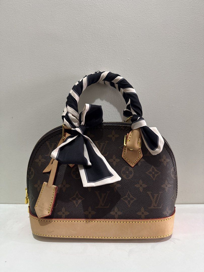 Louis Vuitton Monogram Alma BB with Scarf (Category: Luxury Bags & Wallets) located in Manila. Submitted by ryiaaa (Listing ID 1462739573, Image 1). Description: - Authentic Louis Vuitton Alma BB bag - Classic monogram canvas with vachetta leather trim - Includes a stylish black and white striped scarf tied to the handle - Secure zipper closure - Versatile for everyday or special events - Authenticity tag visible.