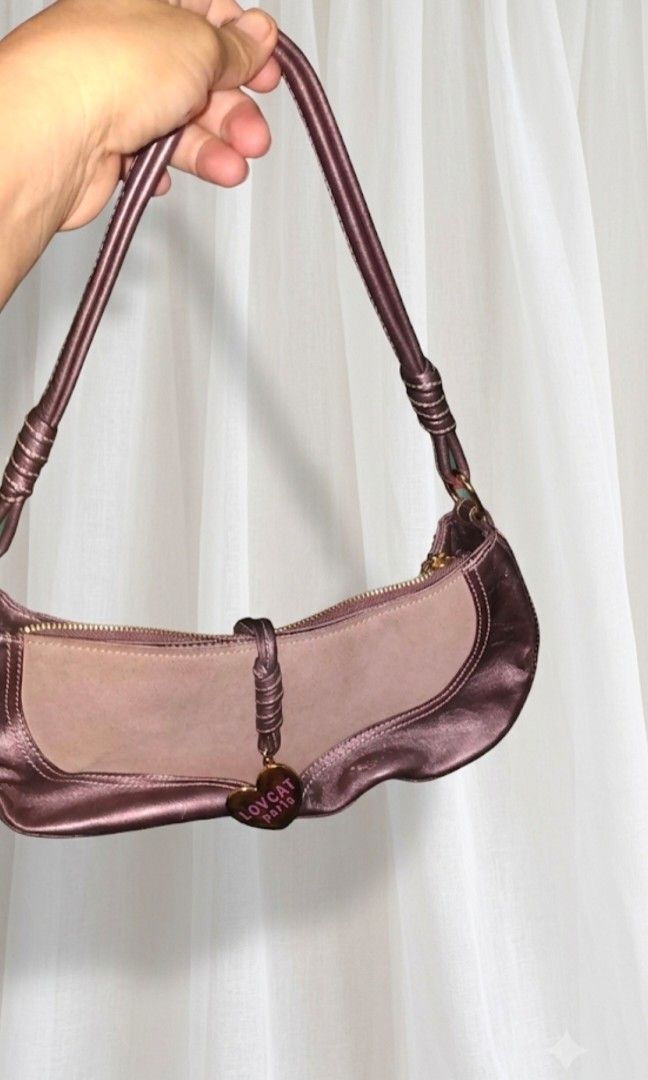 Lovcat Paris Heart Charm Shoulder Bag (Category: Shoulder Bags) located in Cavite. Submitted by sweetalittlemonstertoo (Listing ID 1462813338, Image 1). Description: - Lovcat Paris shoulder bag - Material: Brown leather and taupe suede - Accent: Gold heart charm with brand name - Closure: Zipper - Strap detail: Braided - Ideal for: Everyday use.