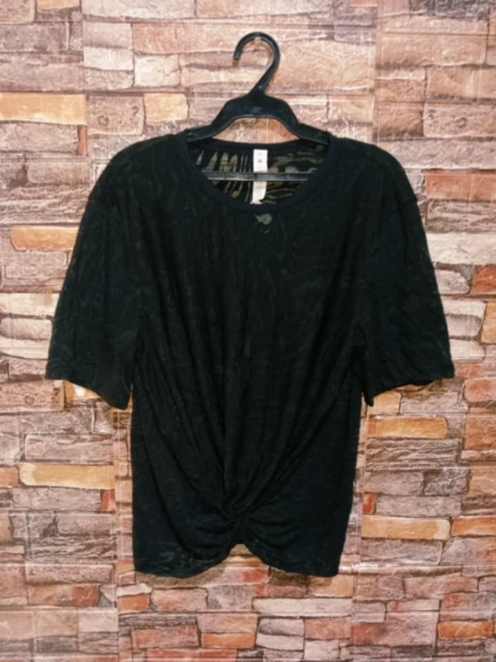 Lululemon Cressent Tee Veil ( dot 6) (Category: Blouses) located in Arayat. Submitted by keenwolf-a7b5 (Listing ID 1462703693, Image 3). Description: - Sheer black fabric - dot 6 - Unique twist front detail - Short sleeves - Crew neck - Subtle patterned texture - Versatile for dressing up or down - Perfect for layering or wearing solo - Easy to style with pants or skirts.