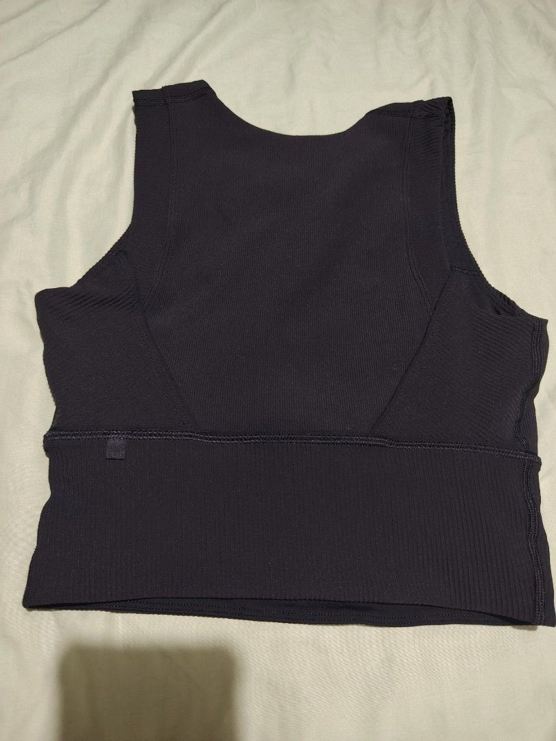Lululemon Ribbed Crop Tank Top Black (Category: Activewear) located in Santa Rosa. Submitted by RRRR0520 (Listing ID 1462804265, Image 3). Description: - Brand: Lululemon - Item: Black ribbed crop tank top - Features: High neckline, sleeveless design - Support: Wide ribbed band at the bottom - Material: Comfortable and stretchy - Versatile: Great for workouts or casual wear - Detail: Shows Lululemon logo tag.