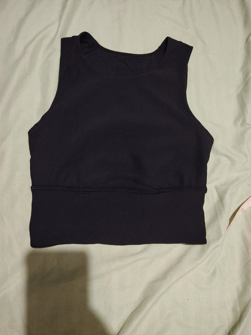 Lululemon Ribbed Crop Tank Top Black (Category: Activewear) located in Santa Rosa. Submitted by RRRR0520 (Listing ID 1462804265, Image 1). Description: - Brand: Lululemon - Item: Black ribbed crop tank top - Features: High neckline, sleeveless design - Support: Wide ribbed band at the bottom - Material: Comfortable and stretchy - Versatile: Great for workouts or casual wear - Detail: Shows Lululemon logo tag.
