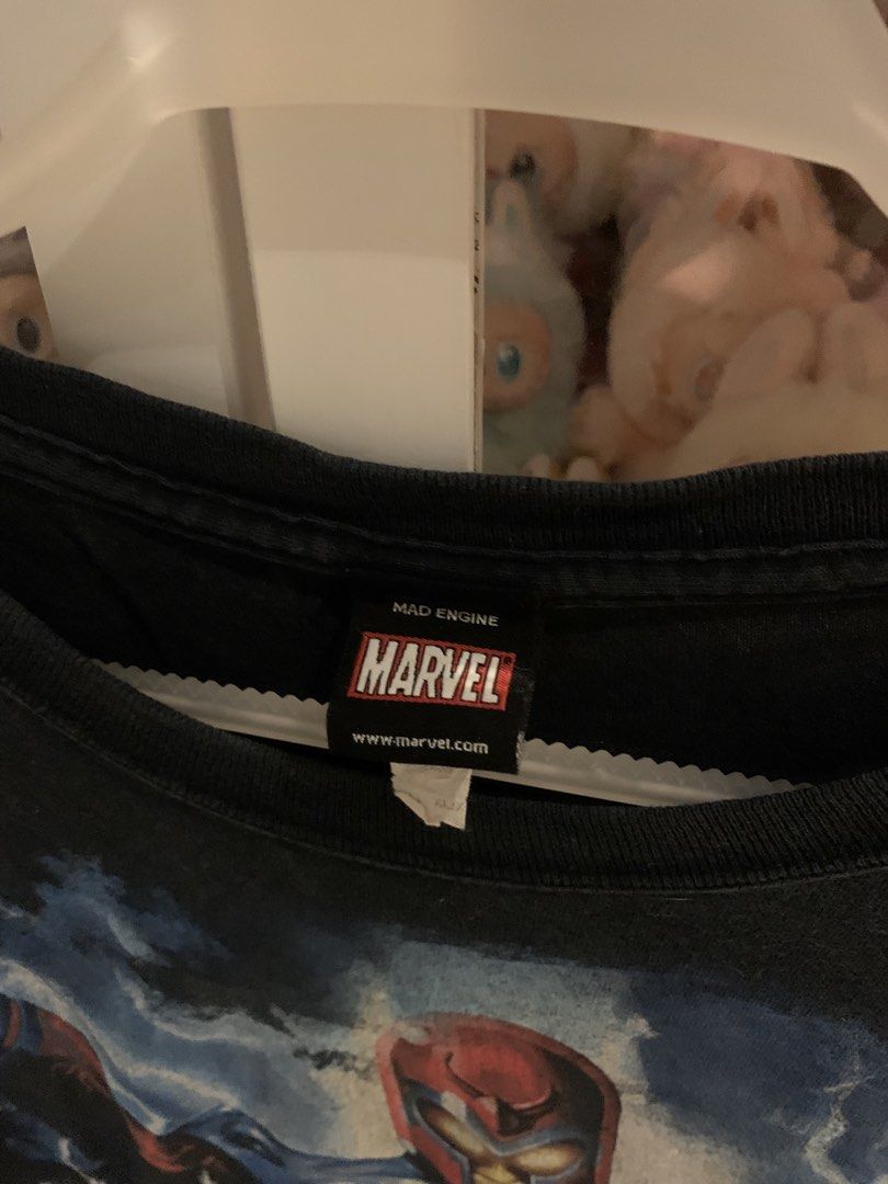 Mad Engine Marvel Comics T-Shirt (Category: Tshirts & Polo Shirts ) located in Manila. Submitted by vintaurafindsco. (Listing ID 1462744989, Image 3). Description: - Black t-shirt with vibrant Marvel Comics graphic print. - Features iconic heroes: Magneto, Hulk, Captain America, Wolverine, Spider-Man, and Iron Man. - A must-have for any Marvel fan! - Brand: Mad Engine.
