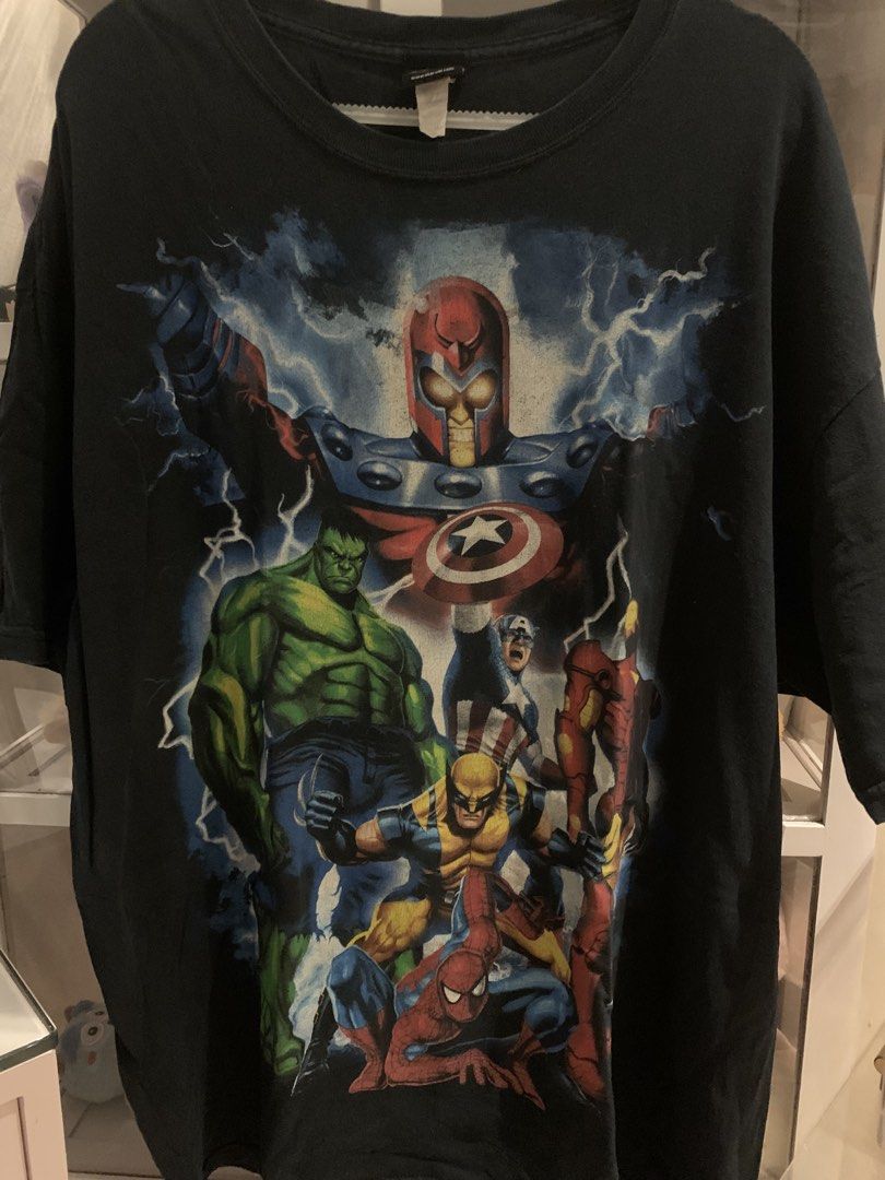 Mad Engine Marvel Comics T-Shirt (Category: Tshirts & Polo Shirts ) located in Manila. Submitted by vintaurafindsco. (Listing ID 1462744989, Image 1). Description: - Black t-shirt with vibrant Marvel Comics graphic print. - Features iconic heroes: Magneto, Hulk, Captain America, Wolverine, Spider-Man, and Iron Man. - A must-have for any Marvel fan! - Brand: Mad Engine.