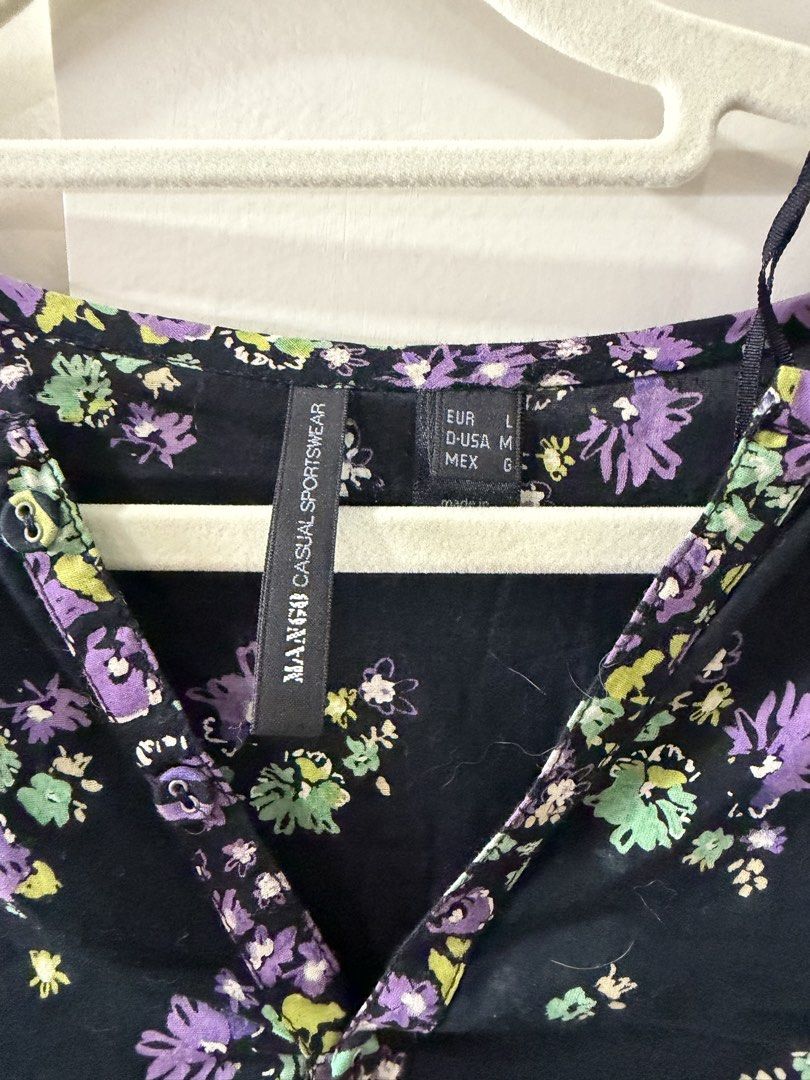 Mango Black Floral Print Long Sleeve Top Size M (Category: Blouses) located in Rosario. Submitted by lovedtwiceph (Listing ID 1462802613, Image 3). Description: - Stylish black top with a purple and green floral print. - Long sleeves with button cuffs. - Flattering V-neckline with functional button details. - Relaxed fit with convenient side slits. - Ideal for everyday casual wear..