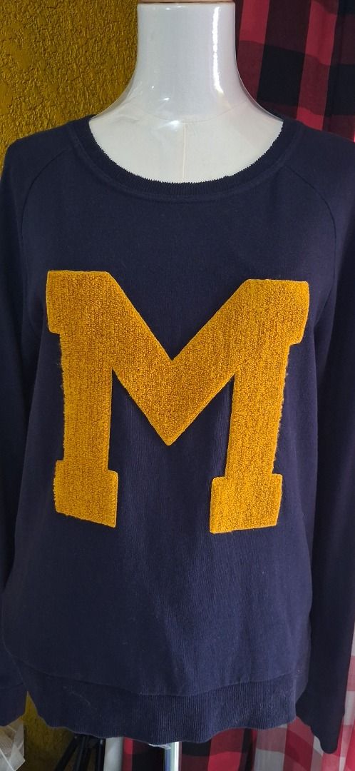 Mango Jeans Navy Blue 'M' Sweater (Category: Coats, Jackets and Outerwear) located in Manila. Submitted by katkween23 (Listing ID 1462730891, Image 2). Description: - Navy blue sweater from Mango Jeans - Features a large yellow 'M' on the front - Striped detail on the sleeves - Crew neck, long sleeves - Ideal for casual wear or showing school spirit.