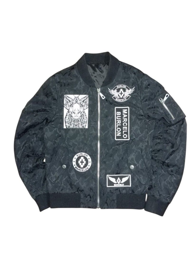Marcelo Burlon Bomber Jacket Black Patches Size 46 (Category: Coats, Jackets and Outerwear) located in Guihulngan. Submitted by jaylordfra13193 (Listing ID 1462861425, Image 1). Description: - Brand: Marcelo Burlon - Style: Bomber Jacket - Color: Black - Design: All-over pattern with multiple front patches - Closure: Zipper - Size: 46 - Origin: Made in Italy - Condition: Please check photos for details Dimes 20x25.5.