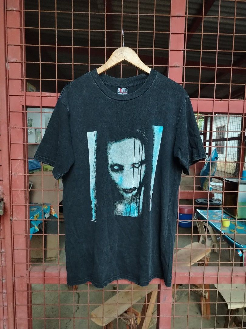 MARILYN MANSON DATED 1998 (Category: Tshirts & Polo Shirts ) located in Don Carlos. Submitted by thriftnidodong_23 (Listing ID 1462804784, Image 1). Description: vintage black Marilyn Manson graphic t-shirt featuring a striking blue-toned face print on the front and a classic Giant brand tag at the collar 2.5-21x30.