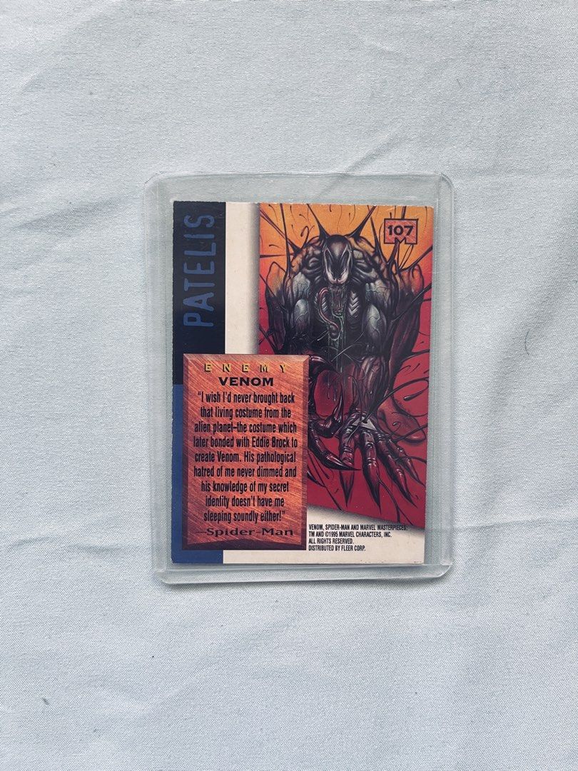 Marvel Masterpieces Venom Trading Card (Category: Raw Singles) located in Cavite. Submitted by _aele3 (Listing ID 1462708574, Image 2). Description: - 1994 Marvel Masterpieces Trading Card - Card Number: 107 - Features: Venom (Spider-Man's enemy) - Front: Cool, dynamic illustration of Venom - Back: Venom quote and character details - Condition: Comes in a protective sleeve.