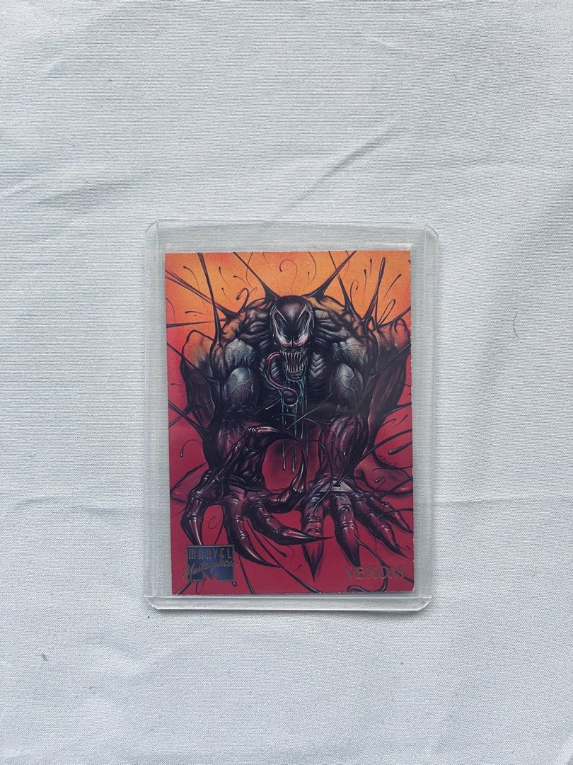 Marvel Masterpieces Venom Trading Card (Category: Raw Singles) located in Cavite. Submitted by _aele3 (Listing ID 1462708574, Image 1). Description: - 1994 Marvel Masterpieces Trading Card - Card Number: 107 - Features: Venom (Spider-Man's enemy) - Front: Cool, dynamic illustration of Venom - Back: Venom quote and character details - Condition: Comes in a protective sleeve.