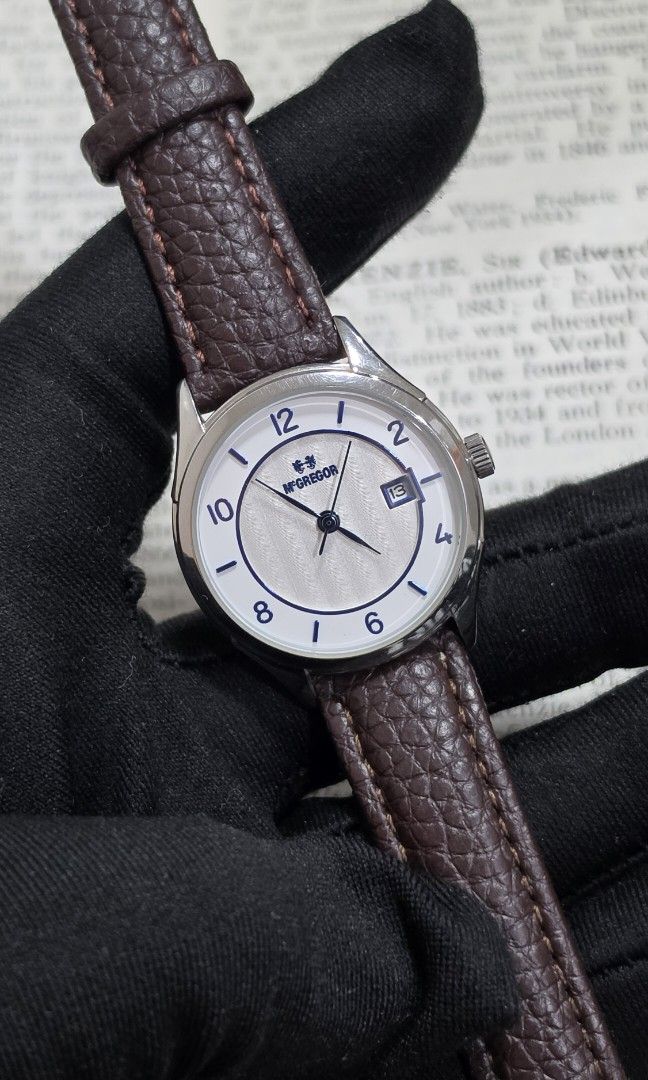 McGregor Women’s Silver Blue Dial Date Watch (Category: Women's Watches) located in Marikina City. Submitted by enoughtimeph (Listing ID 1462730651, Image 1). Description: McGregor Women’s Silver Blue Dial Date Watch Brand: McGregor Ref. No.: MCG-228 Country: Japan Movement: Quartz Dial: White and silver textured dial with blue Arabic numeral indices and date indicator Case: Polished silver tone stainless steel case Strap: Brown leather-style str