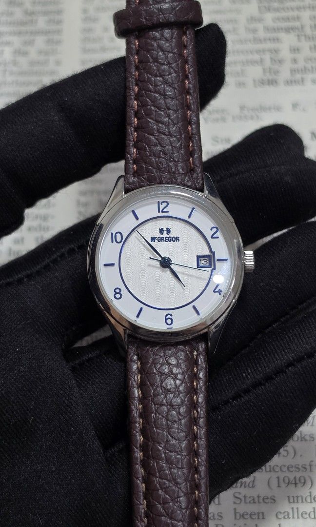 McGregor Women’s Silver Blue Dial Date Watch (Category: Women's Watches) located in Marikina City. Submitted by enoughtimeph (Listing ID 1462730651, Image 2). Description: McGregor Women’s Silver Blue Dial Date Watch Brand: McGregor Ref. No.: MCG-228 Country: Japan Movement: Quartz Dial: White and silver textured dial with blue Arabic numeral indices and date indicator Case: Polished silver tone stainless steel case Strap: Brown leather-style str