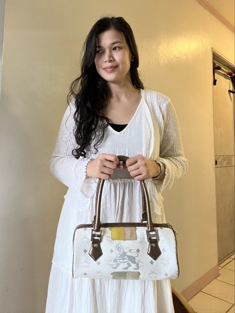MCM Monogram Barrel Bag White Brown (Category: Luxury Bags & Wallets) located in Caloocan City. Submitted by mahanne (Listing ID 1458510096, Image 3). Description: - Authentic MCM barrel bag - Signature monogram print - Brown leather handles and trim - Secure zipper closure - Interior zippered pocket - Unique patchwork side details - Minor interior and exterior marks consistent with normal use - Compact and stylish design.