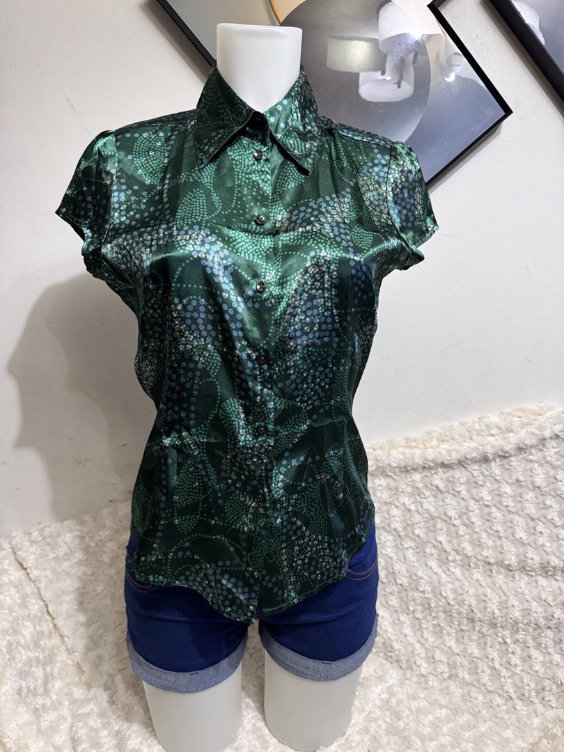 MEXX Green Dotted Short Sleeve Button Up Blouse (Category: Blouses) located in Marikina City. Submitted by lorradel (Listing ID 1462716452, Image 1). Description: - fits S-M (no longer have the plastic) - Brand: MEXX - Color: Green - Sleeve: Short Sleeve - Pattern: Dotted (blue and light green) - Features: Button-up front, collar - Material: Silky - Style: Versatile, dress up or down - MAY HAVE some washable stains (hindi maiiwasan) needs washing