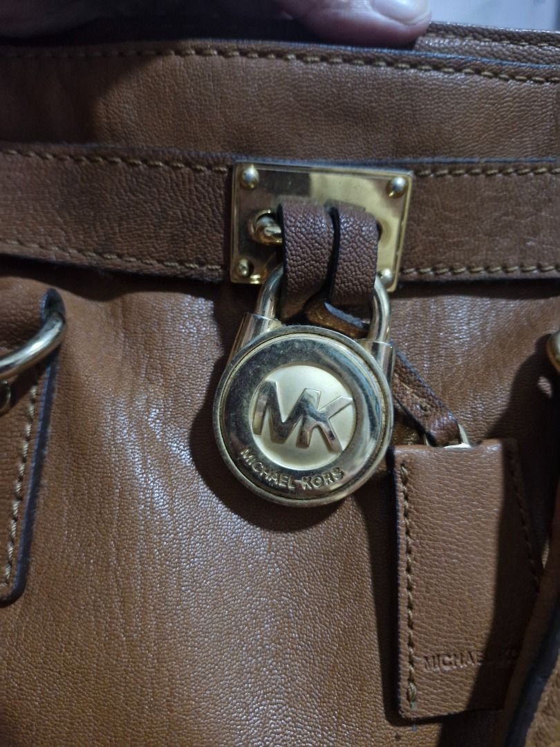 Michael Kors Brown Leather Satchel Handbag (Category: Luxury Bags & Wallets) located in Makati City. Submitted by checatan000888 (Listing ID 1462727714, Image 3). Description: - Genuine brown leather Michael Kors satchel - Versatile with top handles and a detachable shoulder strap - Elegant gold hardware with signature MK logo lock - Spacious interior with a zip pocket and slip pockets - Clean and well-maintained interior - Ideal everyday bag for