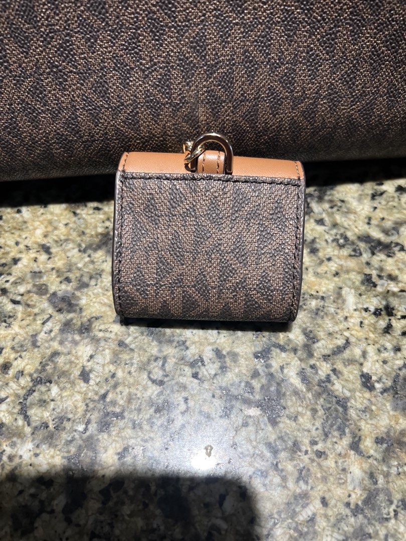Michael Kors Monogram Coin Pouch Keychain/Earpods case (Category: Luxury Bags & Wallets) located in Manila. Submitted by kathlv (Listing ID 1462845049, Image 2). Description: - Original Michael Kors coin pouch/earpods case - Features iconic MK monogram print - Chic brown and tan colorway - Secure snap closure - Convenient keychain attachment - Gold-tone hardware accents - Perfect for coins/earpods.
