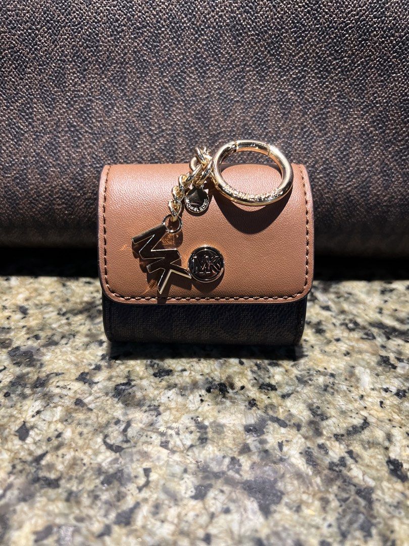 Michael Kors Monogram Coin Pouch Keychain/Earpods case (Category: Luxury Bags & Wallets) located in Manila. Submitted by kathlv (Listing ID 1462845049, Image 1). Description: - Original Michael Kors coin pouch/earpods case - Features iconic MK monogram print - Chic brown and tan colorway - Secure snap closure - Convenient keychain attachment - Gold-tone hardware accents - Perfect for coins/earpods.