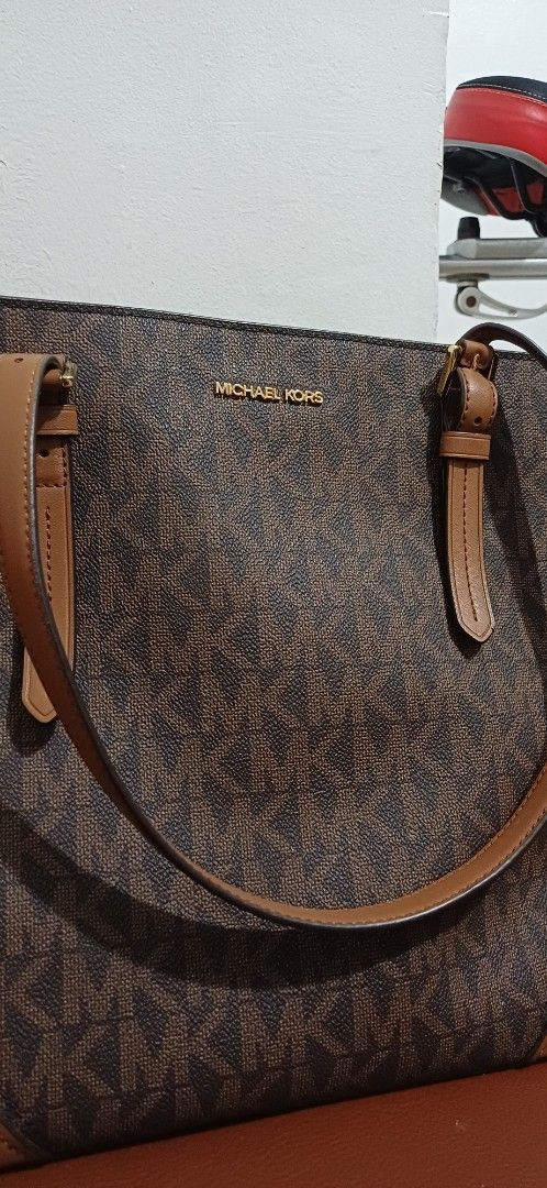 Michael Kors Monogram Tote Bag (Category: Luxury Bags & Wallets) located in Manila. Submitted by leolisa_1026 (Listing ID 1462713881, Image 2). Description: - Classic Michael Kors tote bag - Signature MK monogram print all over - Color: Brown and tan - Material: Leather trim and straps - Features: Spacious interior, gold tone hardware - Perfect for everyday use.