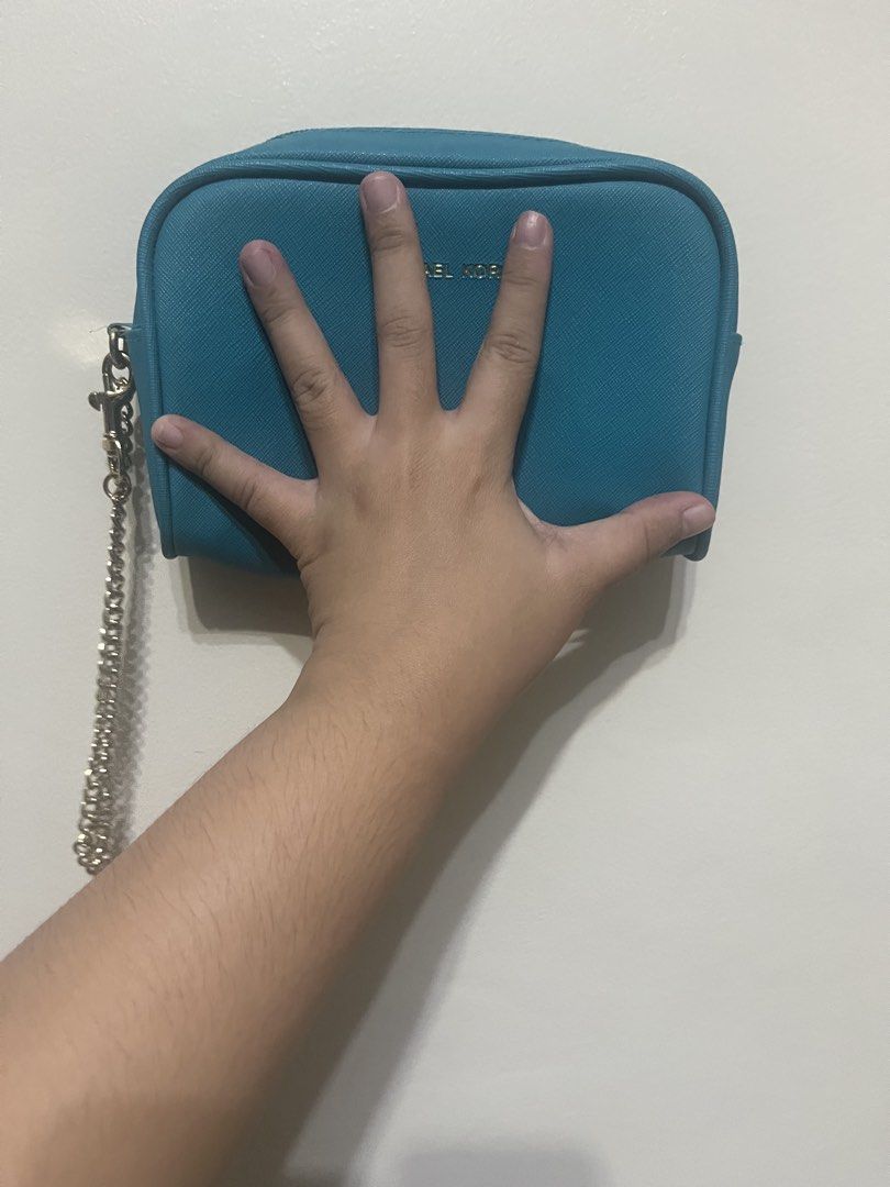 Michael Kors Teal Small Chain Pouch – Preloved (Category: Luxury Bags & Wallets) located in Manila. Submitted by brightshark-0d45dd (Listing ID 1462767399, Image 3). Description: - Blue/Teal Michael Kors cosmetic bag - Genuine Saffiano leather - Chic gold chain strap - Secure zipper closure - Interior pocket for organization - Ideal for makeup and small essentials - Compact size, fits easily in larger bags No receipt/inside tag available..