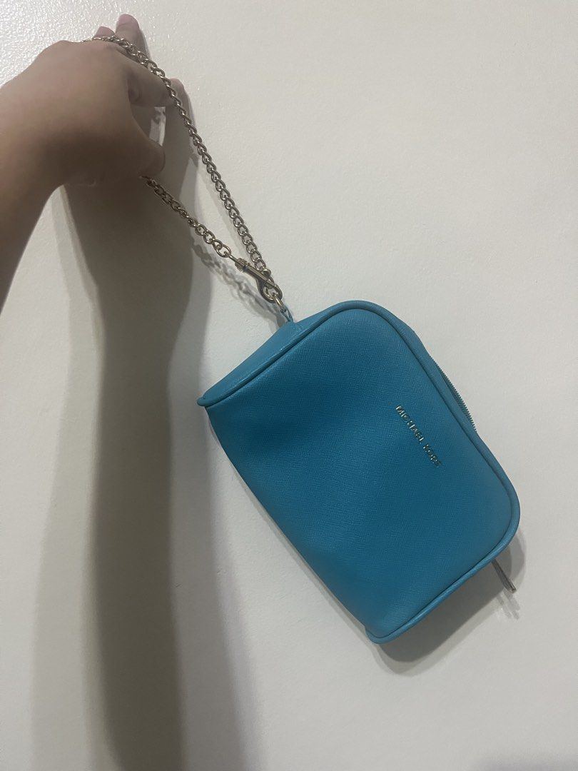 Michael Kors Teal Small Chain Pouch – Preloved (Category: Luxury Bags & Wallets) located in Manila. Submitted by brightshark-0d45dd (Listing ID 1462767399, Image 2). Description: - Blue/Teal Michael Kors cosmetic bag - Genuine Saffiano leather - Chic gold chain strap - Secure zipper closure - Interior pocket for organization - Ideal for makeup and small essentials - Compact size, fits easily in larger bags No receipt/inside tag available..