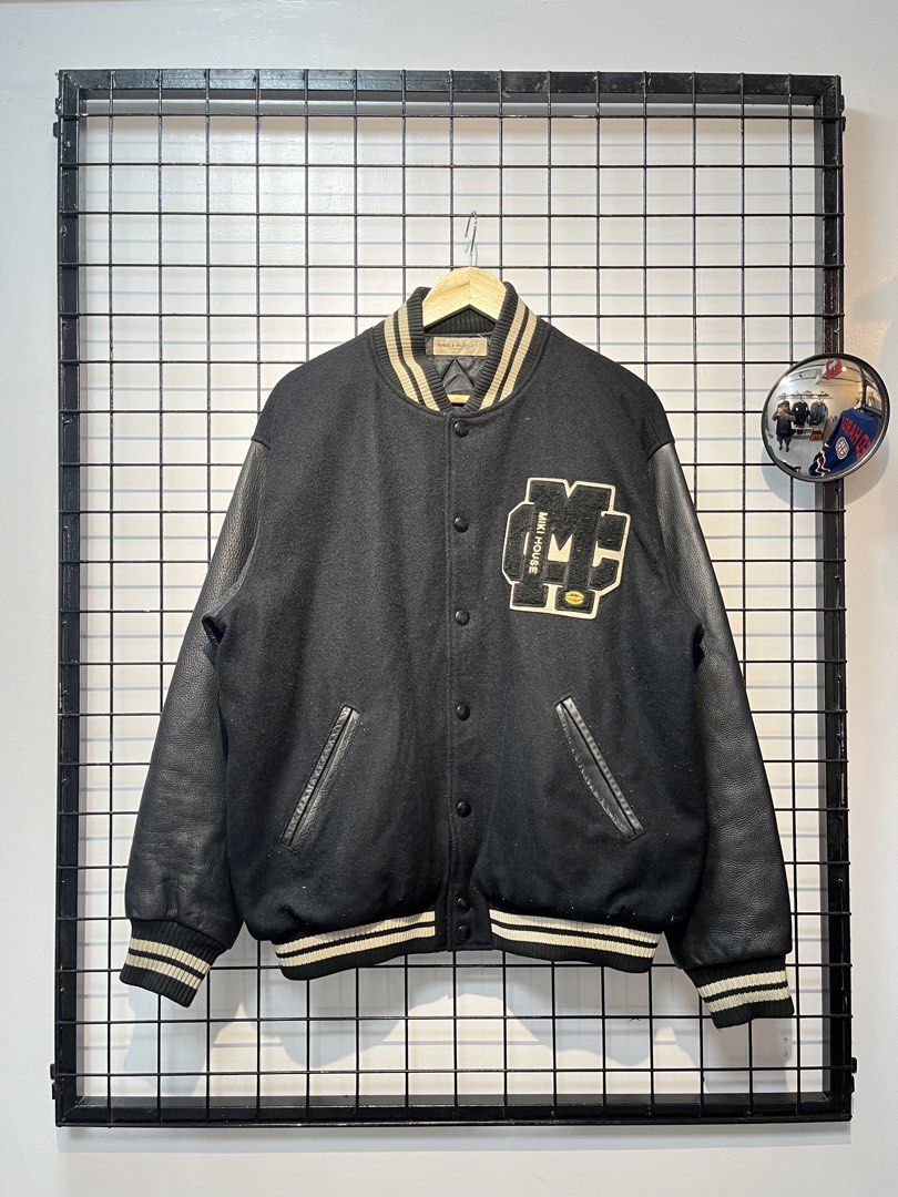 Miki House Varsity Jacket Black Leather Sleeves (Category: Coats, Jackets and Outerwear) located in Taal. Submitted by thrift_deals23 (Listing ID 1462786371, Image 1). Description: - Classic Miki House varsity jacket - Black wool body with leather sleeves - Embroidered logo on front - 'MIKI HOUSE' embroidery on back - Ribbed collar, cuffs, and hem - Button-up closure - Great addition to any collection.