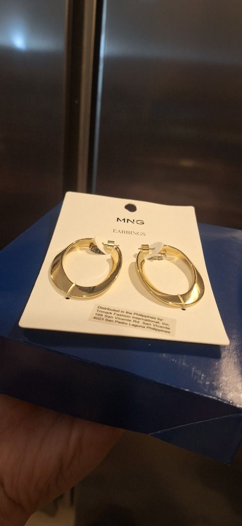 MNG Hoop Earrings (Category: Earrings) located in General Trias. Submitted by aeunice (Listing ID 1462863354, Image 3). Description: Brand: MANGO Gold oval hoop earrings from MNG. Still on the original packaging. Distributed in the Philippines by Trimark Fashion International, Inc. Great for everyday wear or dressing up an outfit. Meet up / Shipping via Lalamove, JnT, Gogo Express & LBC. .
