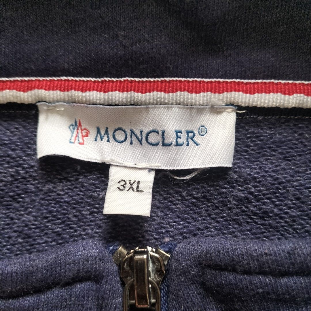 Moncler Navy Blue Track Jacket Size 3XL (Category: Coats, Jackets and Outerwear) located in Taytay. Submitted by calmtree-6248 (Listing ID 1462808009, Image 3). Description: - Navy blue Moncler track jacket - Size: 3XL - Horizontal chest stripes in red, white, and grey - Moncler logo patch on left sleeve - Full zip closure - Ideal for casual wear.