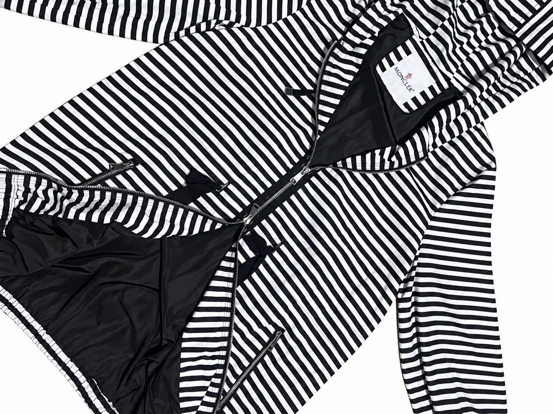 Moncler Striped Zip-Up Hooded Jacket (Category: Coats, Jackets and Outerwear) located in Manila. Submitted by na2oy777 (Listing ID 1462698345, Image 2). Description: - Classic Moncler jacket - Black and white stripe pattern - Zip-up front with hood - Two front pockets with zip closures - Fully lined interior - Made in Romania - Ideal for layering.