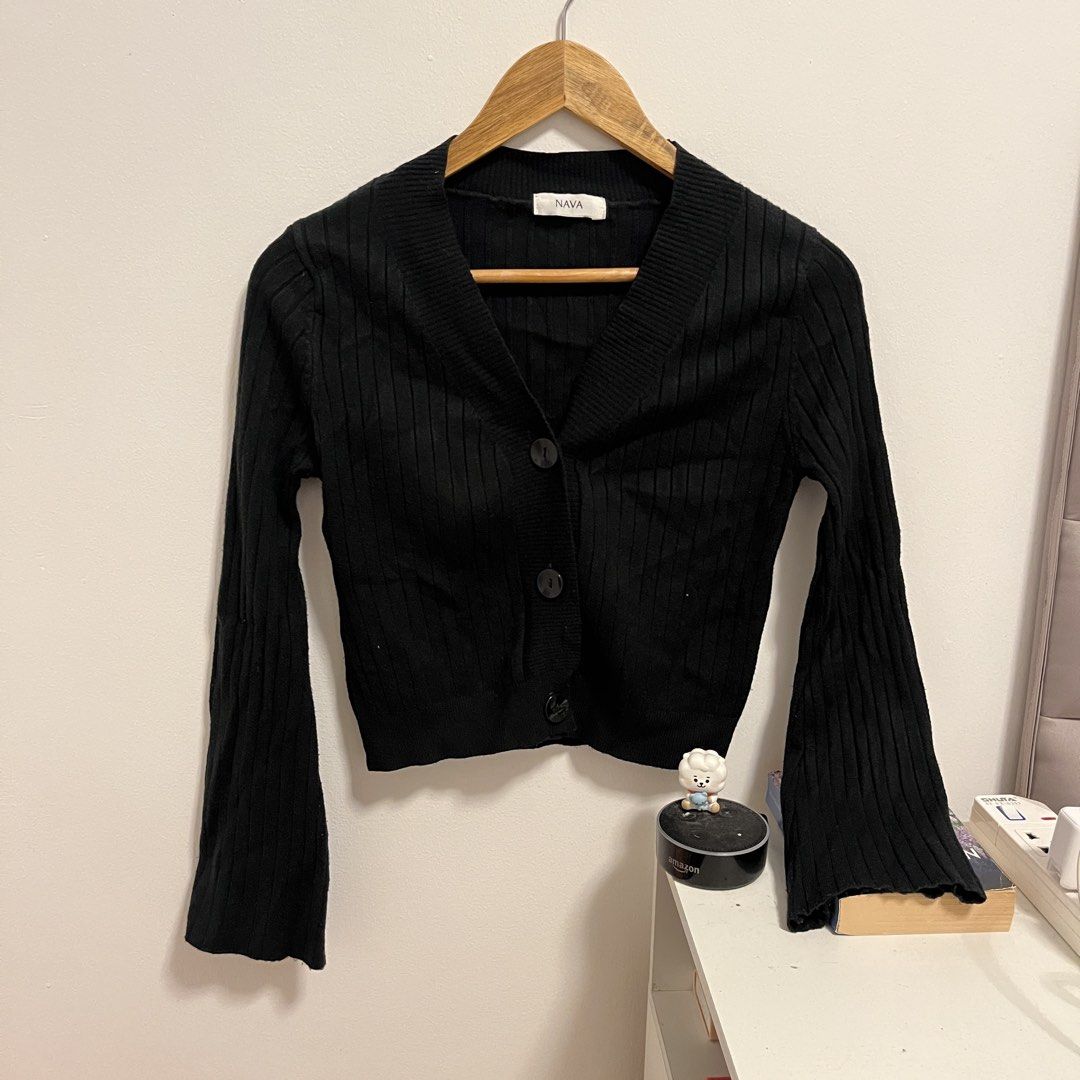 NAVA Black Ribbed Cropped Cardigan (Category: Coats, Jackets and Outerwear) located in Las Pinas. Submitted by thevallerys (Listing ID 1462824094, Image 1). Description: - Brand: NAVA - Style: Black ribbed cropped cardigan - Neckline: V-neck - Closure: Button front - Sleeves: Long sleeves with flared cuffs - Versatility: Great for layering or wearing alone - Styling: Easily pairs with jeans or skirts.