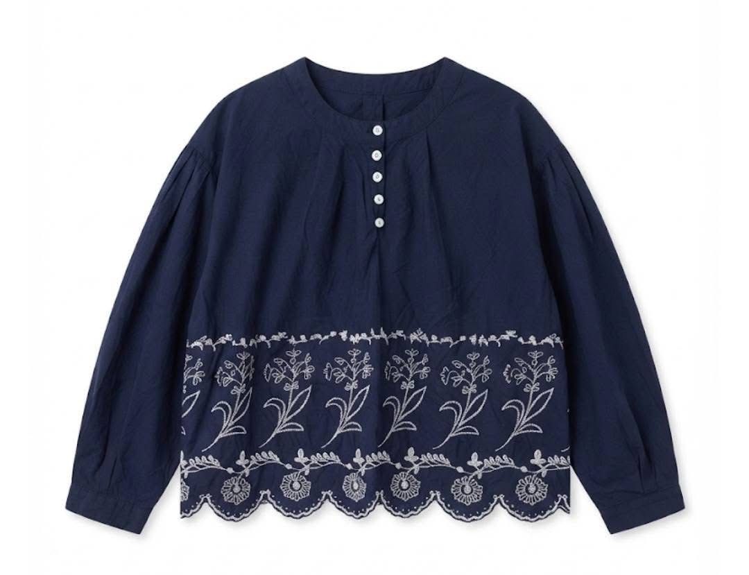 Navy Blue Embroidered Blouse with Button Detail (Category: Blouses) located in Donsol. Submitted by saksthriftavenuebyluckymaria8 (Listing ID 1462880197, Image 2). Description: - Navy blue long-sleeved blouse - White floral embroidery along the hem - Scalloped hem edge - Round neckline with button-up placket - Balloon sleeves - Versatile: pairs well with jeans or skirts - Comfortable and stylish for everyday wear Navy blue Floral Hem Blouse featu