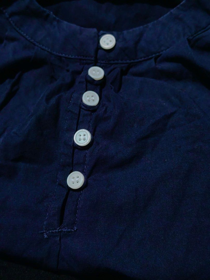 Navy Blue Embroidered Blouse with Button Detail (Category: Blouses) located in Donsol. Submitted by saksthriftavenuebyluckymaria8 (Listing ID 1462880197, Image 3). Description: - Navy blue long-sleeved blouse - White floral embroidery along the hem - Scalloped hem edge - Round neckline with button-up placket - Balloon sleeves - Versatile: pairs well with jeans or skirts - Comfortable and stylish for everyday wear Navy blue Floral Hem Blouse featu
