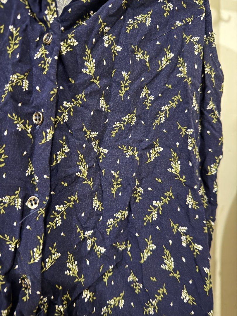 Navy Blue Floral Sleeveless Button-Up Blouse (Category: Blouses) located in Manila. Submitted by lovedbyan (Listing ID 1462878344, Image 2). Description: -S - Navy blue sleeveless blouse - Delicate white and green floral print - Collared neckline - Button-up front - Ideal for casual wear or layering.