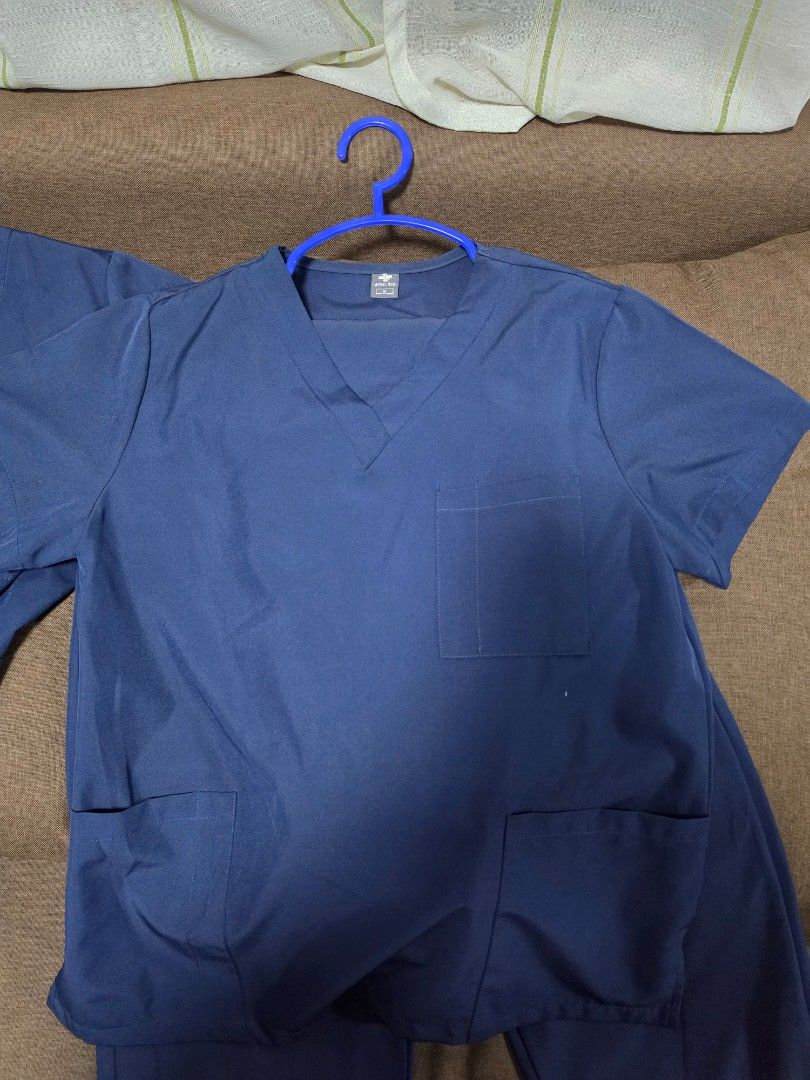 Navy Blue Scrub Top and Pants Set (Category: Activewear) located in Plaridel. Submitted by hello__ag (Listing ID 1462818072, Image 1). Description: - Navy blue scrub set - V-neck top with short sleeves and multiple pockets - Matching scrub pants - Comfortable and durable fabric - Ideal for healthcare professionals - Ready for a new owner.