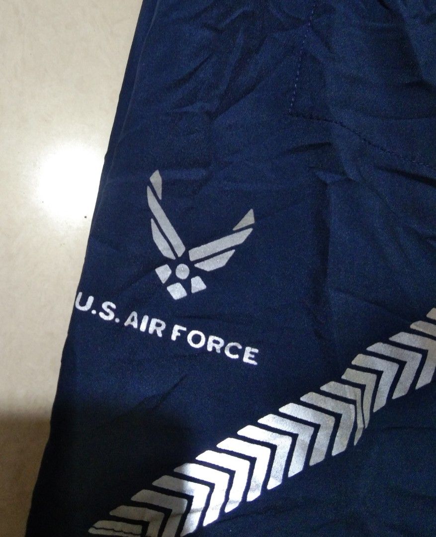 Navy U.S. Air Force Athletic Shorts (Category: Shorts) located in Quezon City. Submitted by aljonbermu25659 (Listing ID 1462685637, Image 3). Description: - Navy blue athletic shorts - Features U.S. Air Force logo on left leg - Reflective chevron detailing on lower back - Elastic waistband with adjustable drawstring - Ideal for workouts and casual wear.