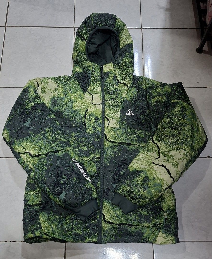 Nike ACG Therma-Fit ADV Primaloft Puffer Jacket (Category: Coats, Jackets and Outerwear) located in Makati City. Submitted by coleencloset (Listing ID 1462824676, Image 2). Description: - Nike ACG Green Camouflage Puffer Jacket - Size: Medium (M) - Insulation: Primaloft for superior warmth - Technology: Therma-Fit ADV for advanced thermal regulation - Origin: Made in Vietnam - Style: Unique camouflage print, ideal for outdoor adventures or everyd