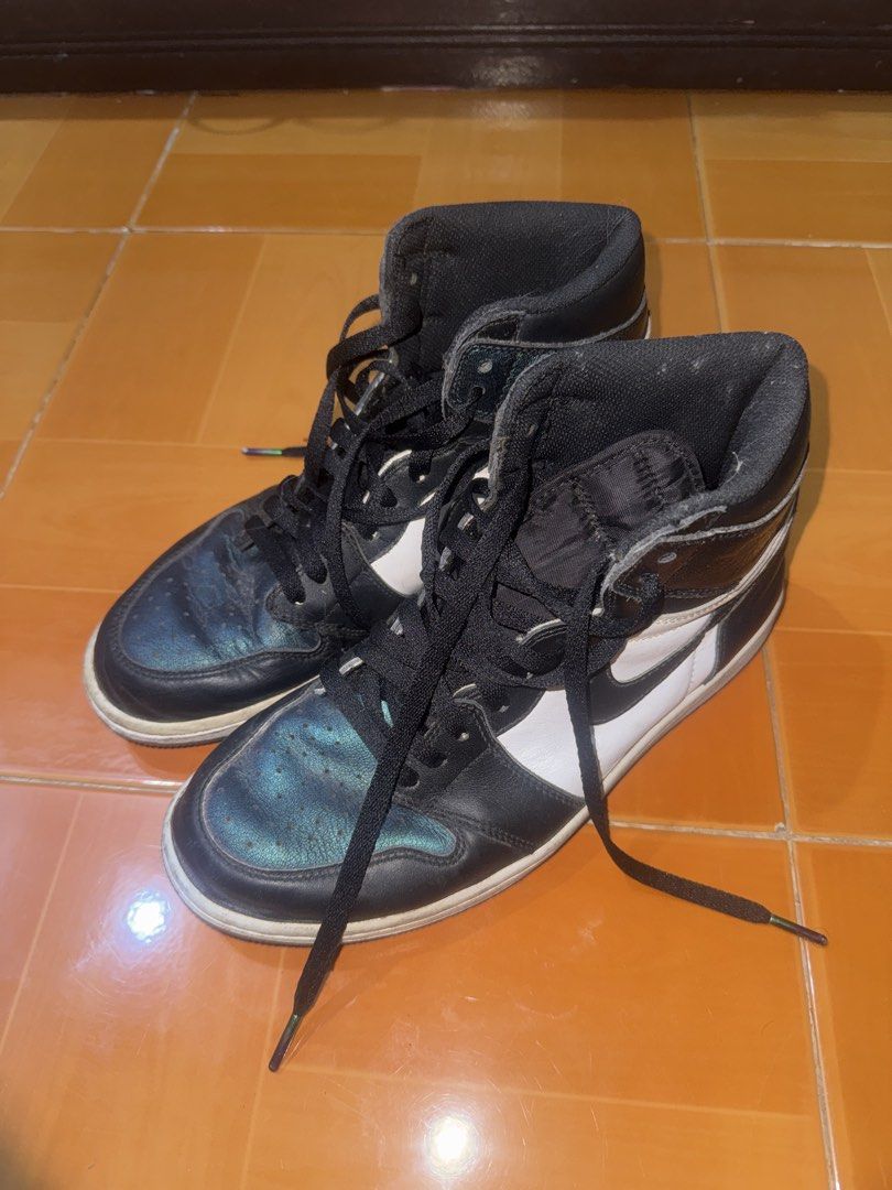 Nike Air Jordan 1 High OG (Category: Sneakers) located in Manila. Submitted by soteriya_ (Listing ID 1462696786, Image 1). Description: - Black and white high-top Jordans - Unique iridescent sheen on the toe box - Black laces - White soles - Pre-loved, but with plenty of life left - Perfect for casual wear.