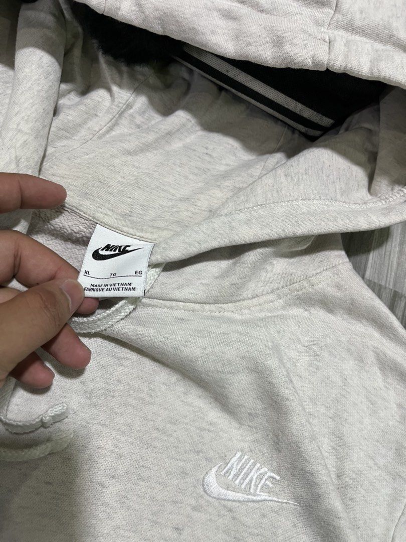 Nike Grey Pullover Hoodie Sweatshirt (Category: Coats, Jackets and Outerwear) located in Cavite. Submitted by arespichri90266 (Listing ID 1462699933, Image 3). Description: - Grey Nike Hoodie - Size XL (25x26) - Small embroidered Nike logo on chest - Drawstring hood - Front pocket - Ideal for everyday wear - issue: Minimal pink stain (not very visible) .