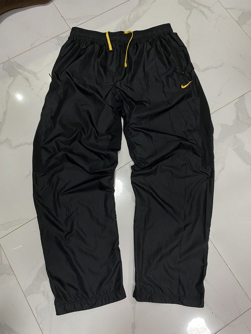 Nike Live Strong Track Pants Black Yellow (Category: Joggers) located in Taguig. Submitted by jhayarpuen15676 (Listing ID 1462775897, Image 1). Description: - Black Nike track pants - Yellow accent details - Drawstring waist for adjustable fit - Zippered pockets for secure storage - "Live Strong" logo prominently displayed - Zippers along the legs for customizable fit - Ideal for athletic activities or everyday casual style - Waistline 32-46 - Le