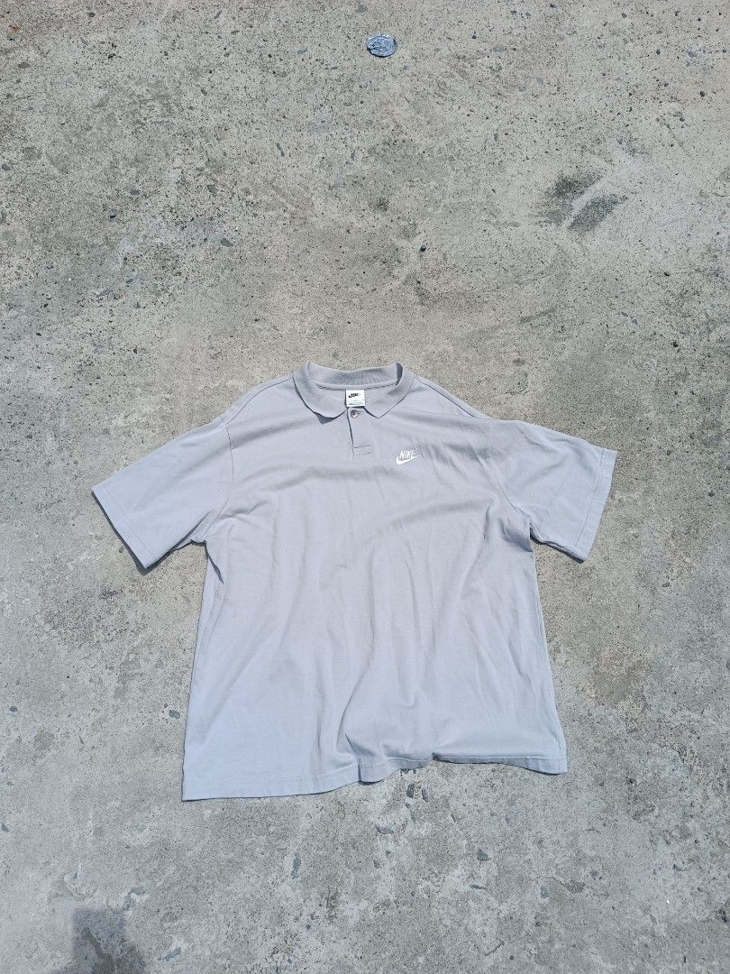 Nike Men's Grey Polo Shirt (Category: Tshirts & Polo Shirts ) located in Urdaneta. Submitted by tetsudoubletaps (Listing ID 1462739585, Image 1). Description: Fits L to XL 24 x 29 - Grey Nike Polo Shirt - Size: Large (L) on tag - Material: 100% Cotton - Origin: Made in Pakistan - Design: Simple, classic, perfect for casual or sporty looks - Features: Button closure at neck, embroidered Nike logo on chest.