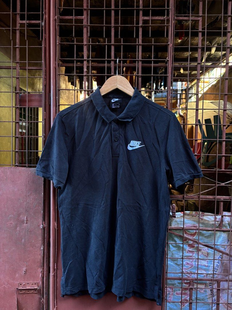 Nike Polo Shirt Black Size M (Category: Tshirts & Polo Shirts ) located in Manila. Submitted by thriftkibs (Listing ID 1462827648, Image 1). Description: - Black Nike Polo Shirt - Size: Medium (M) - Material: 100% Cotton - Origin: Made in China - Features: Embroidered Nike logo on chest, two-button placket - Ideal for: Casual wear.