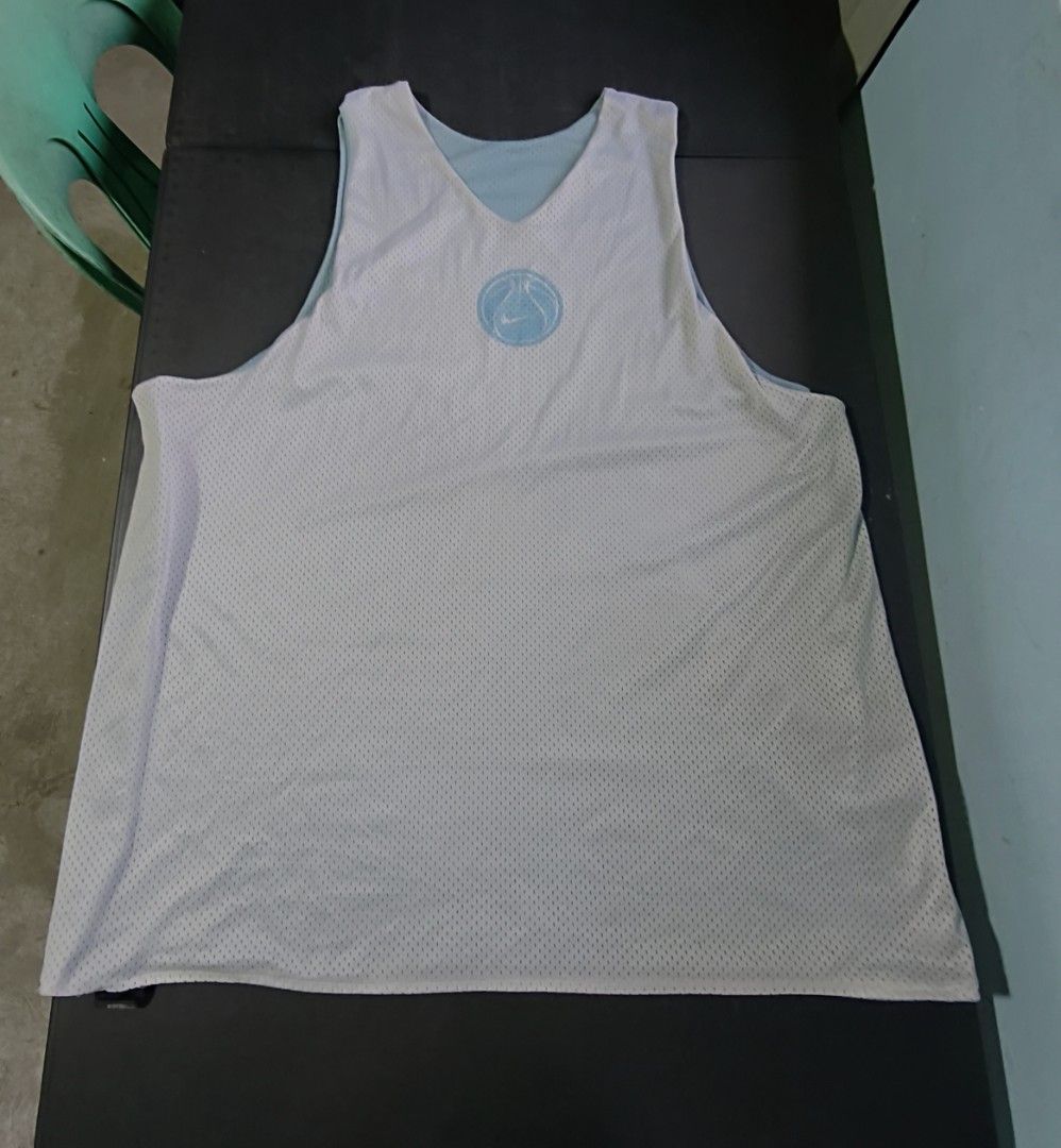 Nike Reversible Basketball Jersey (Category: Activewear) located in Cavite. Submitted by billcleantone (Listing ID 1462791691, Image 2). Description: - Reversible Nike basketball jersey - Side 1: Light blue with embroidered Nike swoosh - Side 2: White with blue basketball graphic - Made of breathable mesh material - Ideal for basketball games or everyday casual wear.