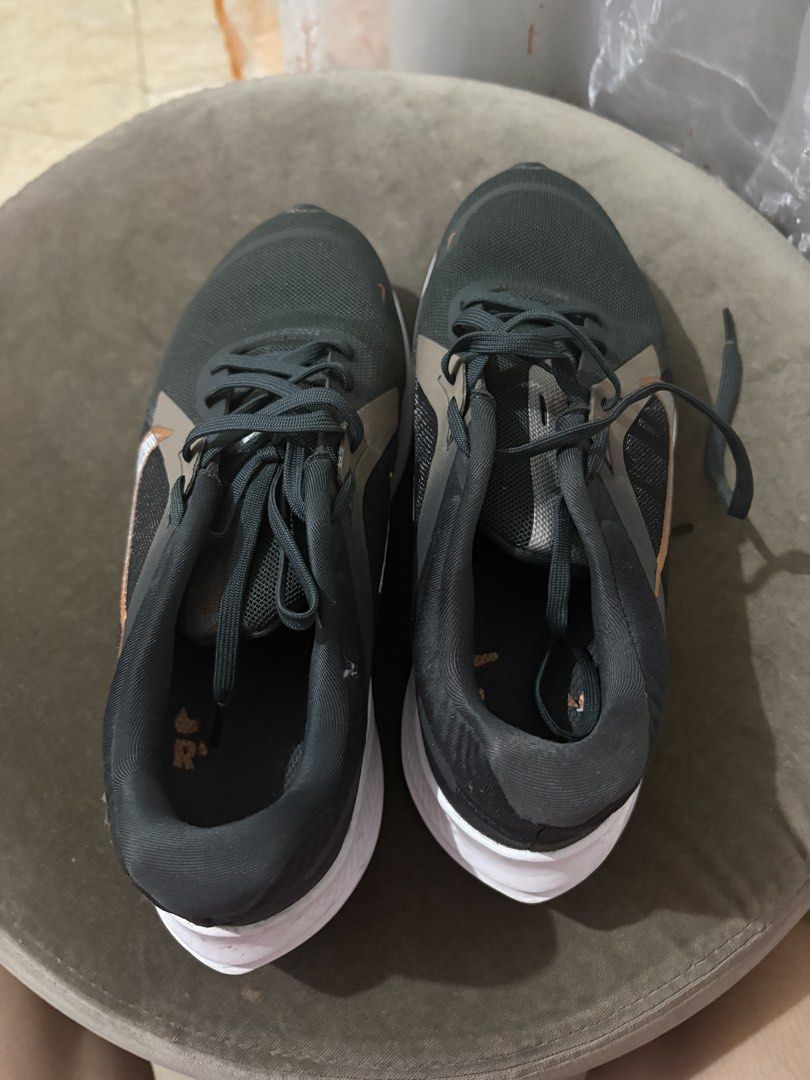 Nike Running Shoes (Category: Sneakers) located in Caloocan City. Submitted by majaliwalas (Listing ID 1462833674, Image 2). Description: - Dark grey Nike running shoes - White and copper accents - Breathable mesh upper - Durable rubber outsole - Suitable for running or everyday wear.