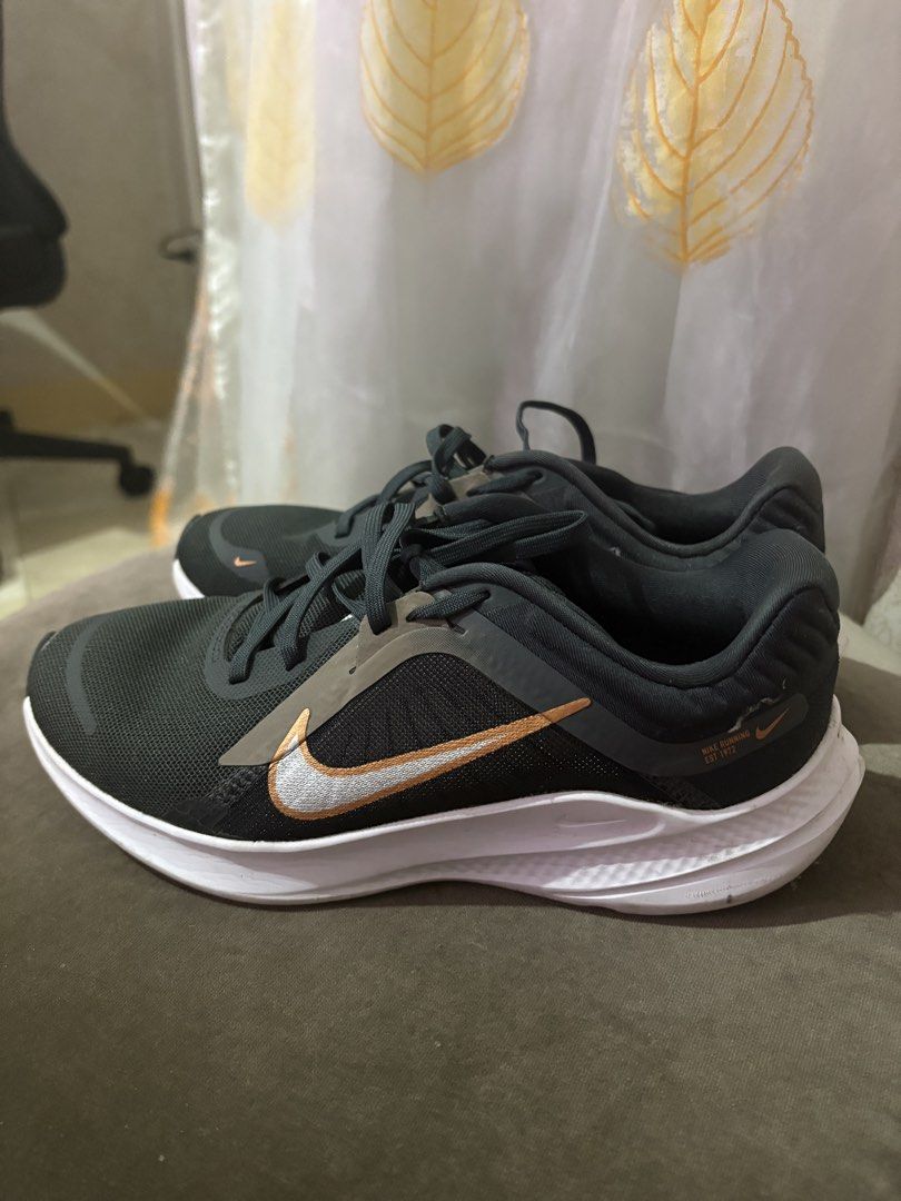 Nike Running Shoes (Category: Sneakers) located in Caloocan City. Submitted by majaliwalas (Listing ID 1462833674, Image 1). Description: - Dark grey Nike running shoes - White and copper accents - Breathable mesh upper - Durable rubber outsole - Suitable for running or everyday wear.