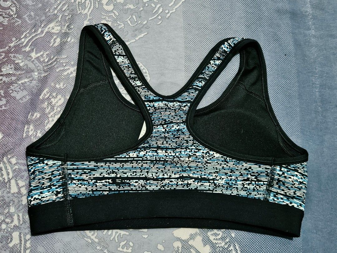 Nike Sports Bra Medium Blue/Black/White Pattern (Category: Activewear) located in Quezon City. Submitted by randzcruz (Listing ID 1462686005, Image 2). Description: Nike sports bra, size M. Features a stylish blue, black, and white abstract design with a supportive racerback. Made with recycled materials for a sustainable choice..