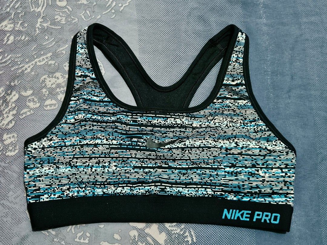 Nike Sports Bra Medium Blue/Black/White Pattern (Category: Activewear) located in Quezon City. Submitted by randzcruz (Listing ID 1462686005, Image 1). Description: Nike sports bra, size M. Features a stylish blue, black, and white abstract design with a supportive racerback. Made with recycled materials for a sustainable choice..