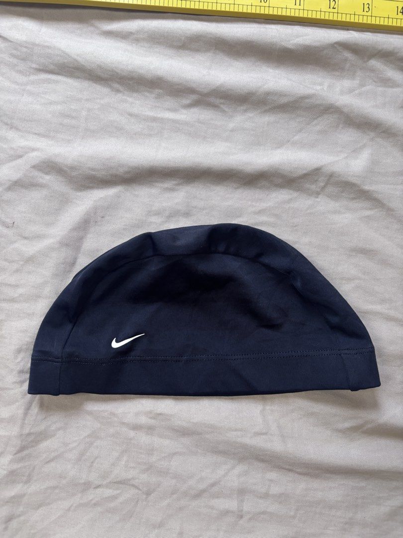 Nike Swim Cap Black (Category: Caps & Hats) located in Andop. Submitted by ukaylangpo (Listing ID 1462771666, Image 2). Description: - Classic navy blue Nike swim cap - Features the iconic Nike swoosh logo - Made from durable material for long-lasting use - Stretchy fit for a secure and comfortable feel - Ideal for both training and casual swimming sessions.