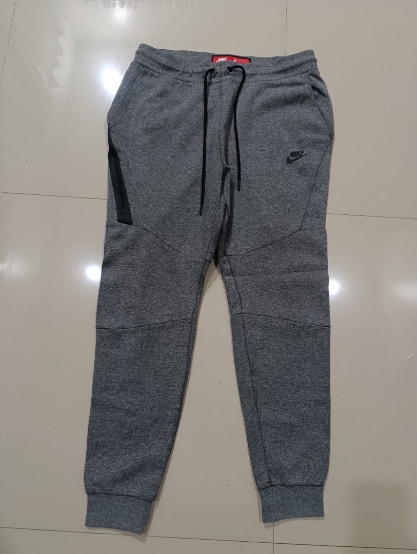 Nike Tech Fleece Grey Jogger Pants Size M (Category: Joggers) located in Davao. Submitted by idioticthrifter (Listing ID 1462868584, Image 1). Description: - Grey Nike Tech Fleece Joggers - Size: Medium - Classic Nike logo on left leg - Zippered pockets for secure storage - Made in China - Perfect for casual wear or workouts - 29-32 waist x 37 length.
