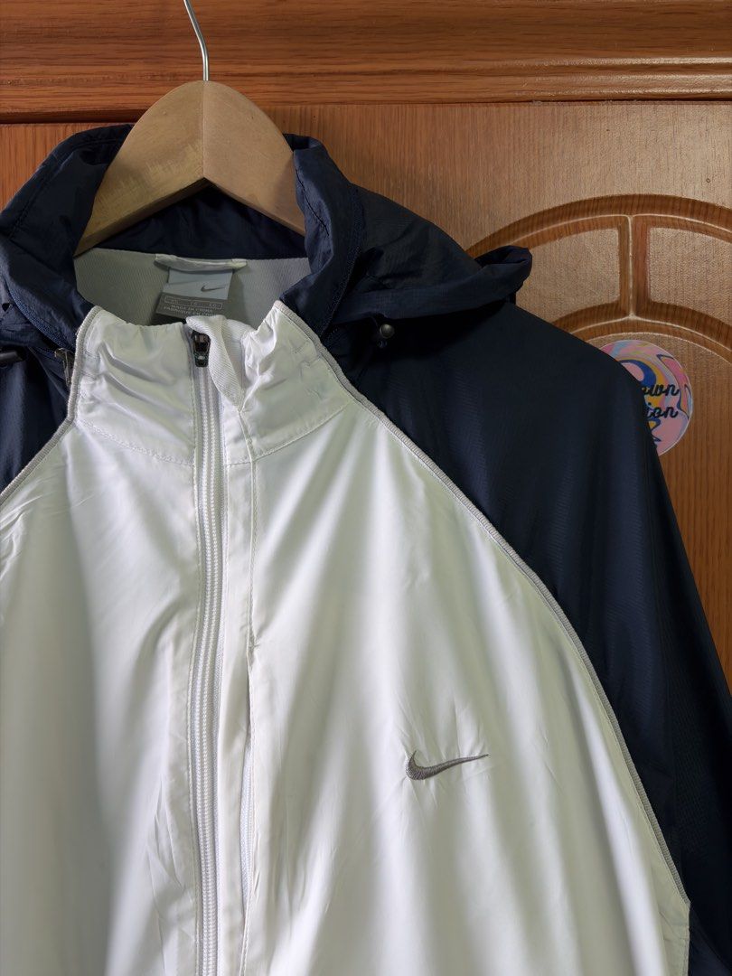 Nike Windbreaker Jacket Navy White XL (Category: Coats, Jackets and Outerwear) located in Caloocan City. Submitted by puremountain.2e6573 (Listing ID 1462860049, Image 2). Description: - Brand: Nike - Type: Windbreaker Jacket - Size: XL - Color: Navy Blue and White - Features: Hooded, suitable for light rain or wind - Condition: Small mark on the inside of the white panel (refer to last photo) - Origin: Made in China.