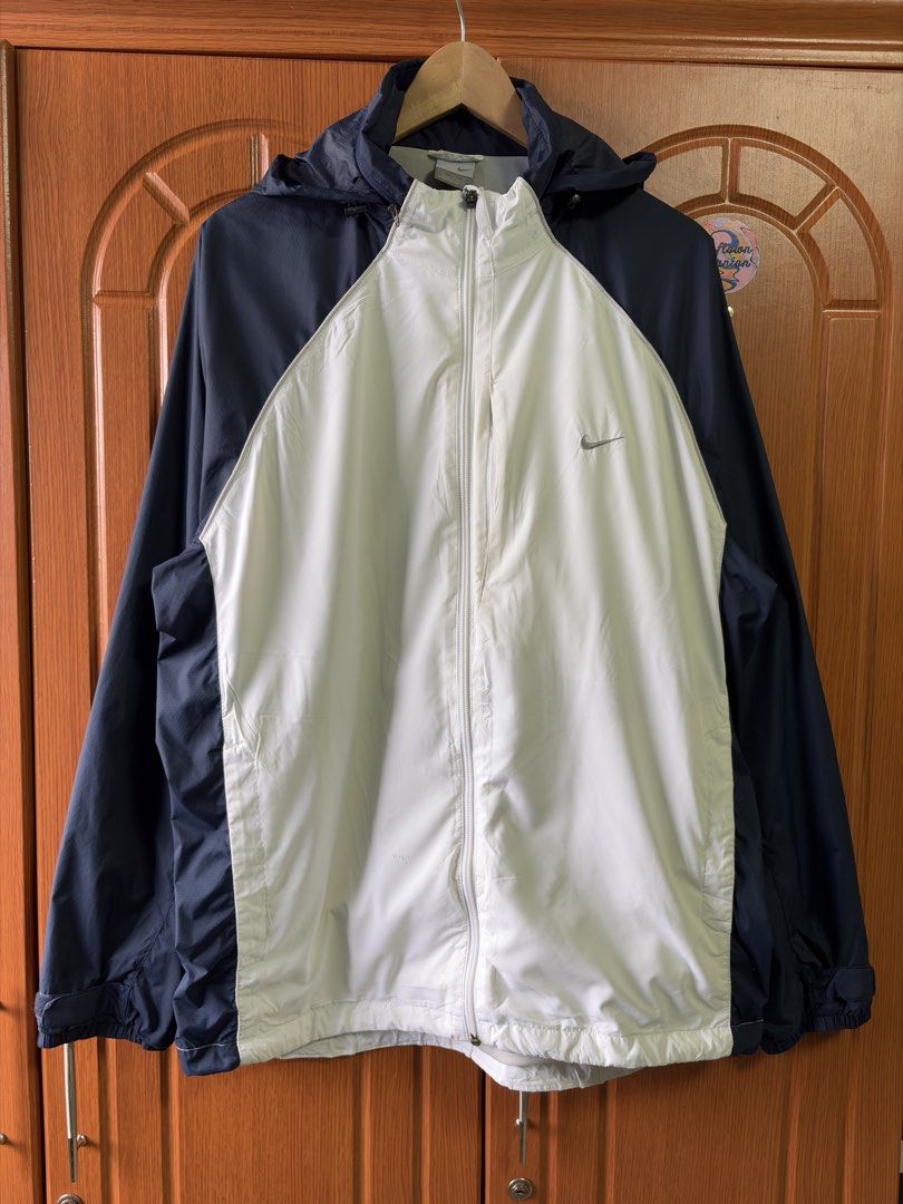 Nike Windbreaker Jacket Navy White XL (Category: Coats, Jackets and Outerwear) located in Caloocan City. Submitted by puremountain.2e6573 (Listing ID 1462860049, Image 1). Description: - Brand: Nike - Type: Windbreaker Jacket - Size: XL - Color: Navy Blue and White - Features: Hooded, suitable for light rain or wind - Condition: Small mark on the inside of the white panel (refer to last photo) - Origin: Made in China.