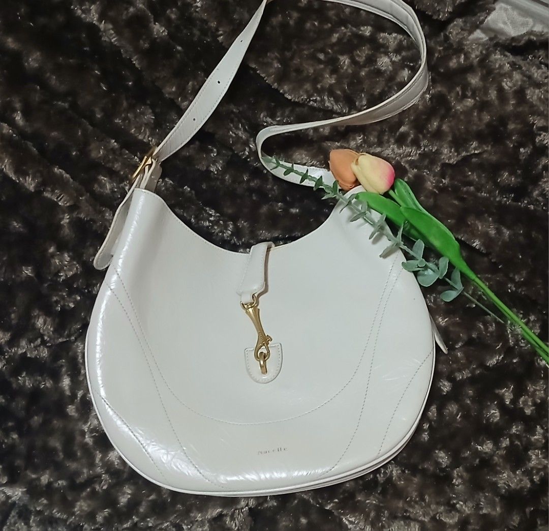 Nucelle White Leather Shoulder Bag (Category: Shoulder Bags) located in Taguig. Submitted by jegadablo (Listing ID 1462746669, Image 3). Description: - Brand: Nucelle - Material: White Leather - Design: Unique curved shape - Hardware: Gold accents - Strap: Adjustable - Features: Spacious interior - Ideal for: Everyday use.